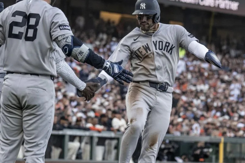 New York Yankees shortstop Jose Caballero (R) scores against the San Francisco Giants on Wednesday at Oracle Park in San Francisco. Photo by Terry Schmitt/UPI