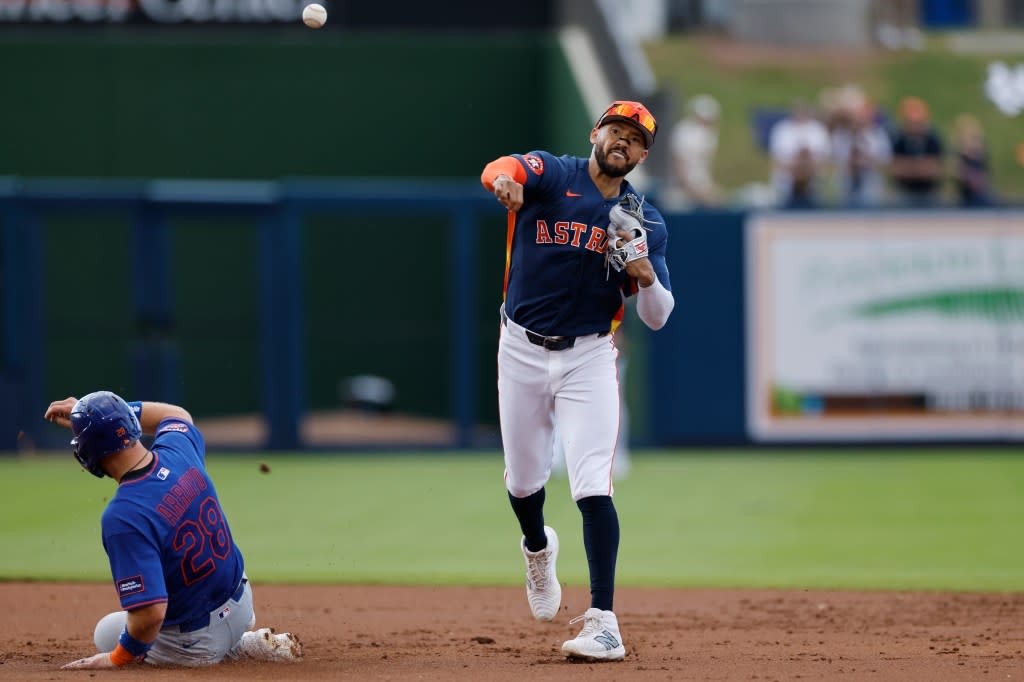 Carlos Correa (1) of the Houston Astros turns a double play over the slide by Christian Arroyo (28) of the New York Mets during a spring training game on March 14, 2026 at CACTI Park of the Palm Beaches in West Palm Beach, Florida. Icon Sportswire via Getty Images