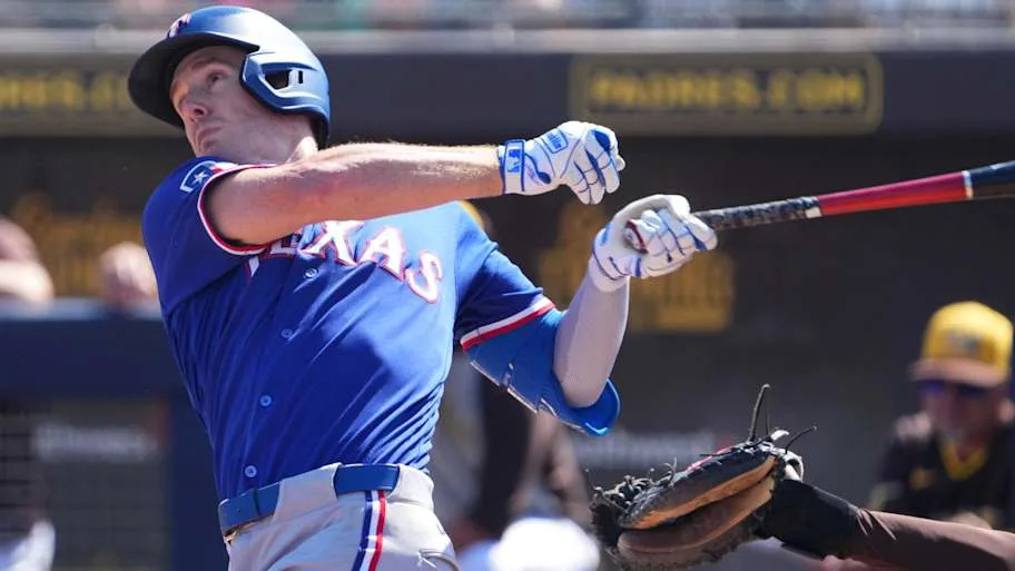 Texas Rangers center fielder Evan Carter swings his bat during a game.