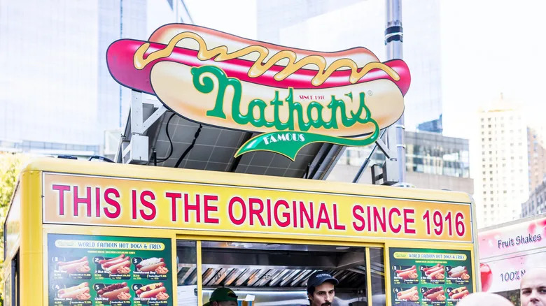 Colorful Nathan's Famous Hot Dog sign above a Nathan that's a famous hot dog booth