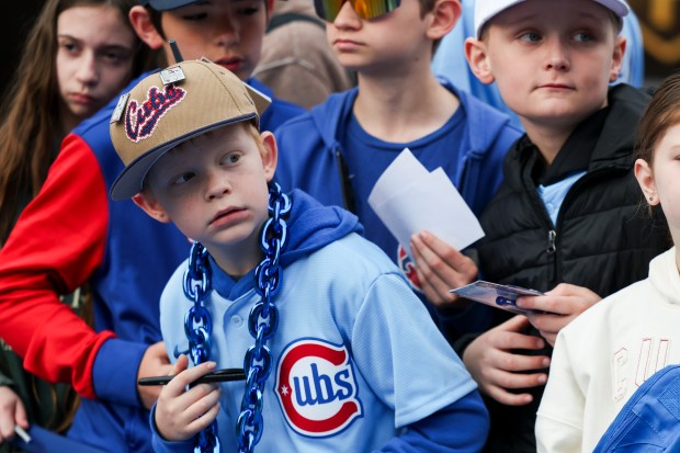 Easton Smith waits to get an autograph from Pete Crow-Armstrong outside Wrigley Field before the Chicago Cubs host the Washington Nationals on opening day, March 26, 2026. (Eileen T. Meslar/Chicago Tribune)