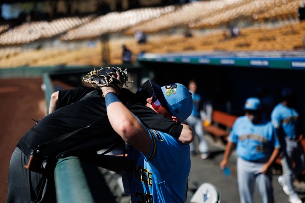 Milwaukee Brewers first baseman Andrew Vaughn hugs Chicago White Sox photographer Darren Georgia before playing the Sox in a Cactus League game at Camelback Ranch on Sunday Feb. 22, 2026 in Glendale, Ariz. (Armando L. Sanchez/Chicago Tribune)