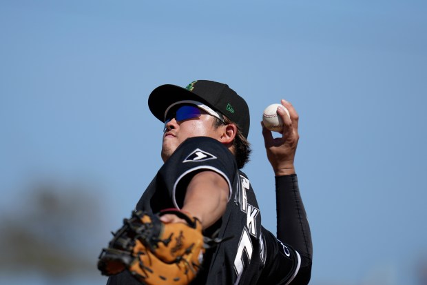 Chicago White Sox first baseman Munetaka Murakami tosses a baseball into the crowd during the third inning of a spring training baseball game against the Athletics, Tuesday, March 17, 2026, in Phoenix. (AP Photo/Ross D. Franklin)