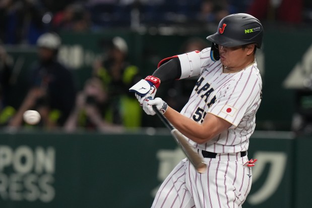 Japan's Munetaka Murakami hits a grand slam home run during the eighth inning of a World Baseball Classic game between Japan and the Czech Republic on Tuesday, March 10, 2026 in Tokyo. (AP Photo/Eugene Hoshiko)