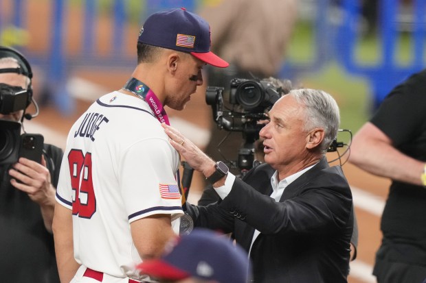 MLB Commissioner Rob Manfred talks to United States right fielder Aaron Judge during the awards ceremony following the championship game of the World Baseball Classic against Venezuela, Tuesday, March 17, 2026, in Miami. (AP Photo/Lynne Sladky)
