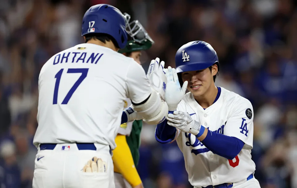 Los Angeles Dodgers second baseman Hyeseong Kim (6) celebrates with designated hitter Shohei Ohtani (17) after hitting a home run during the fifth inning against the Athletics at Dodger Stadium.