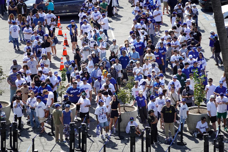 Aug 27, 2025; Los Angeles, California, USA; Fans wait in line to receive a bobblehead of Los Angeles Dodgers player Shohei Ohtani before the game against the Cincinnati Reds at Dodger Stadium. Mandatory Credit: Kirby Lee-Imagn Images