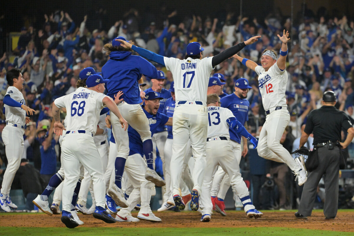 Oct 27, 2025; Los Angeles, California, USA; The Los Angeles Dodgers celebrate after first baseman Freddie Freeman (5) hit a walk off home run against the Toronto Blue Jays in the eighteenth inning during game three of the 2025 MLB World Series at Dodger Stadium. Mandatory Credit: Jayne Kamin-Oncea-Imagn Images