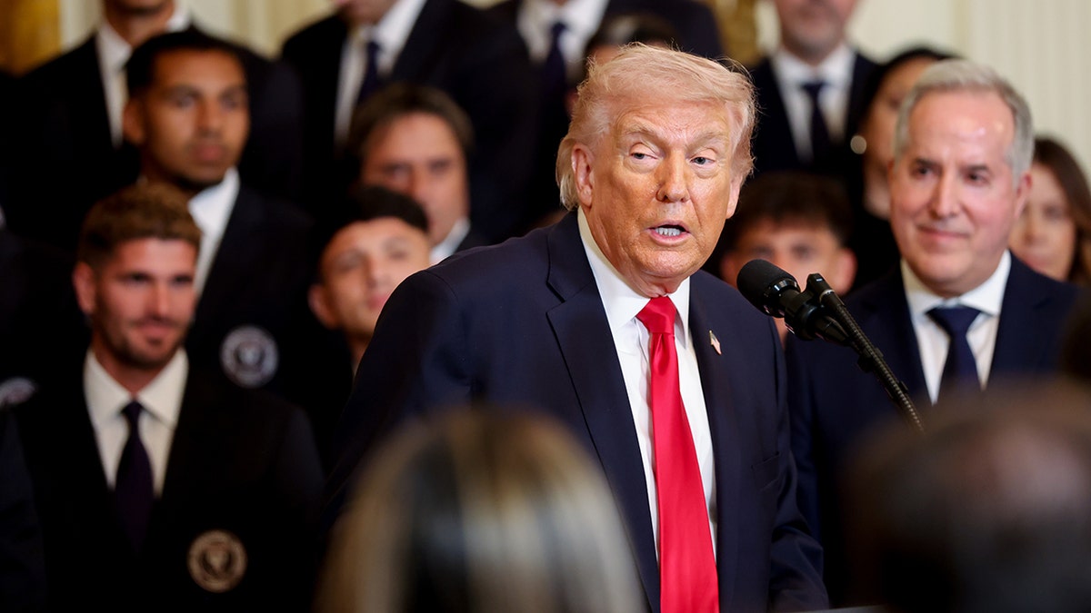 Donald Trump looks on