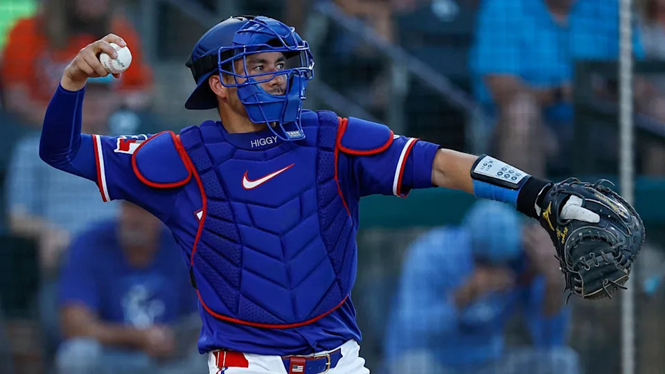 <div>SURPRISE, ARIZONA - MARCH 18: Kyle Higashioka #11 of the Texas Rangers throws a warm up toss during a Spring Training game against the Kansas City Royals at Surprise Stadium on March 18, 2026 in Surprise, Arizona. (Photo by Brandon Sloter/Getty Images)</div>