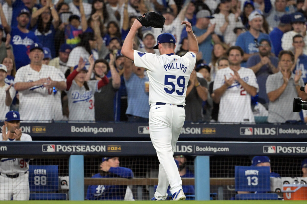 Oct 11, 2024; Los Angeles, California, USA; Los Angeles Dodgers pitcher Evan Phillips (59) reacts after being relieved in the seventh inning against the San Diego Padres during game five of the NLDS for the 2024 MLB Playoffs at Dodger Stadium. Mandatory Credit: Jayne Kamin-Oncea-Imagn Images