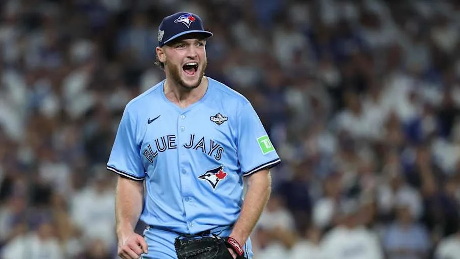 Trey Yesavage shouts to celebrate an out on the mound in a baby blue Blue Jays unifor