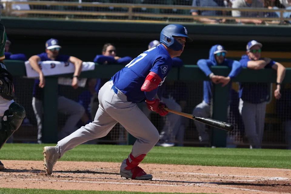 Los Angeles Dodgers left fielder Ryan Ward (67) hits an RBI double against the Athletics in the second inning at Hohokam Stadium.