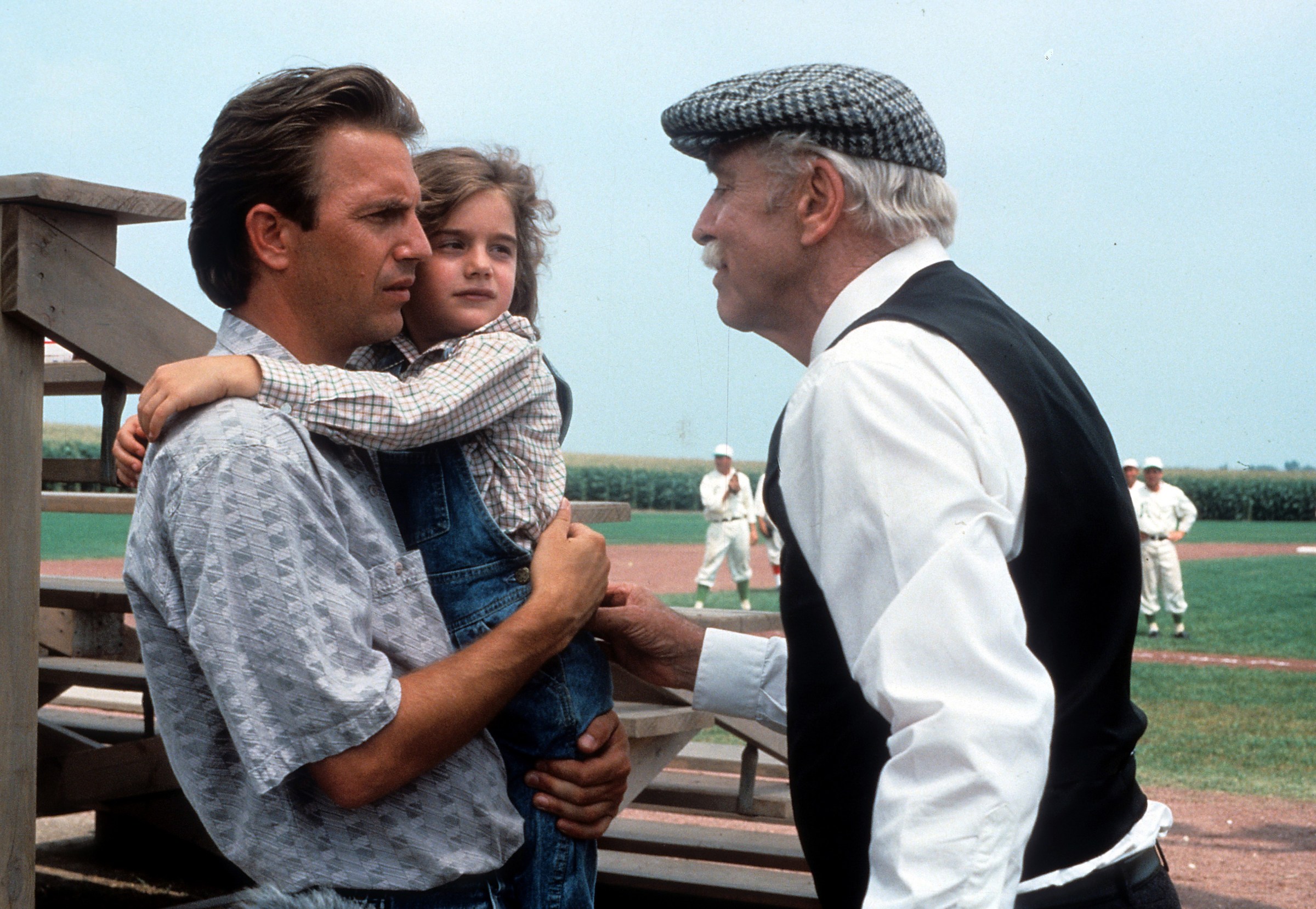 Kevin Costner holding Gaby Hoffmann in a scene from the film ‘Field Of Dreams’, 1989. (Photo by Universal/Getty Images)