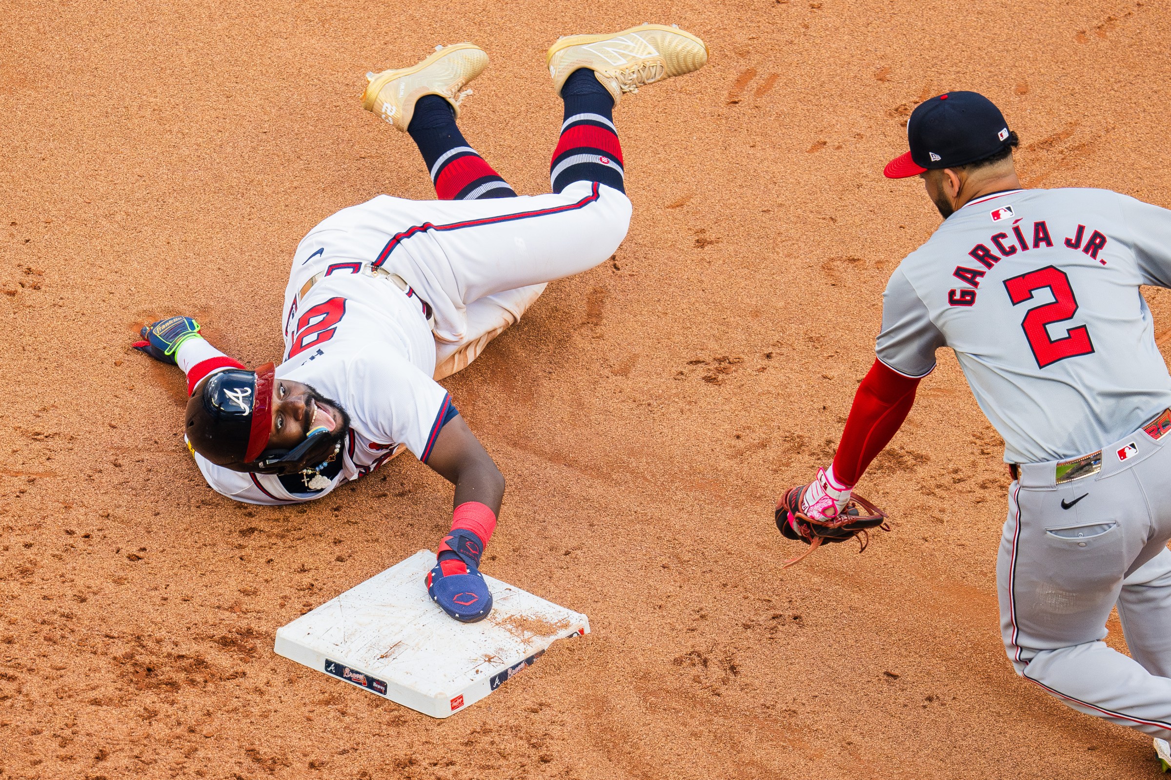 ATLANTA, GA - MAY 27: Michael Harris II #23 of the Atlanta Braves smiles at Luis García Jr. #2 of the Washington Nationals after stealing second during the seventh inning at Truist Park on May 27, 2024 in Atlanta, Georgia. (Kevin D. Liles/Atlanta Braves/Getty Images)
