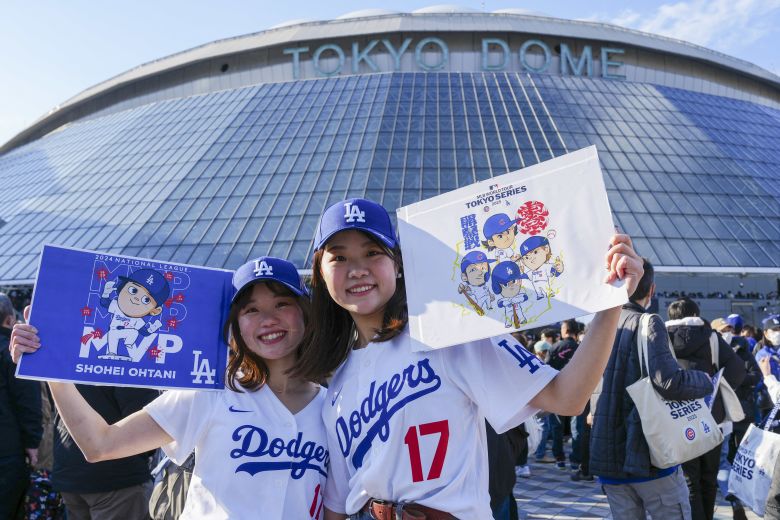 Fans pose for a photo ahead of a Tokyo Series game last year.