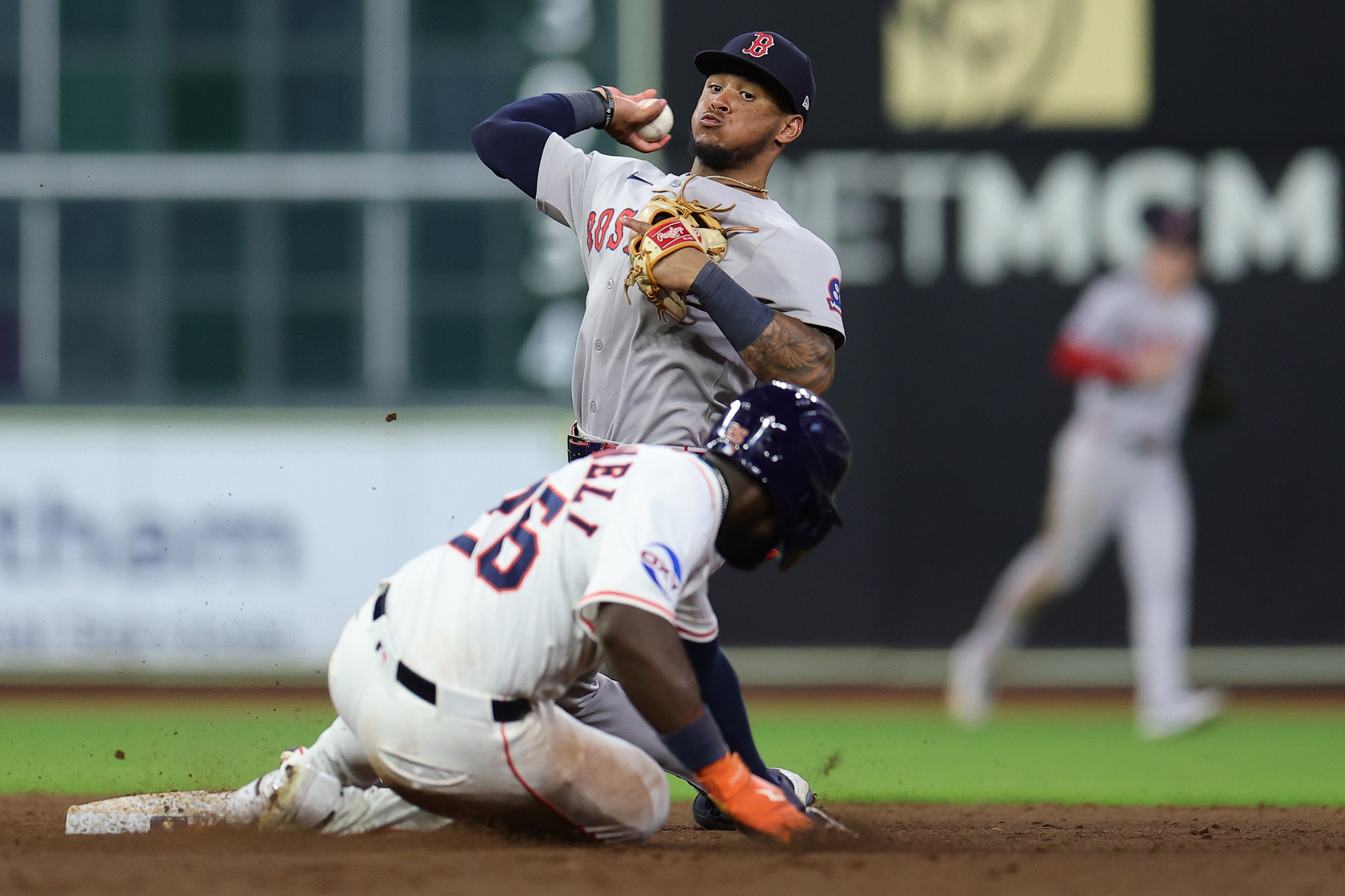 HOUSTON, TEXAS - AUGUST 12: Ceddanne Rafaela #3 of the Boston Red Sox throws to first after forcing out Taylor Trammell #26 of the Houston Astros at second base during the ninth inning at Daikin Park on August 12, 2025 in Houston, Texas. (Photo by Alex Slitz/Getty Images)