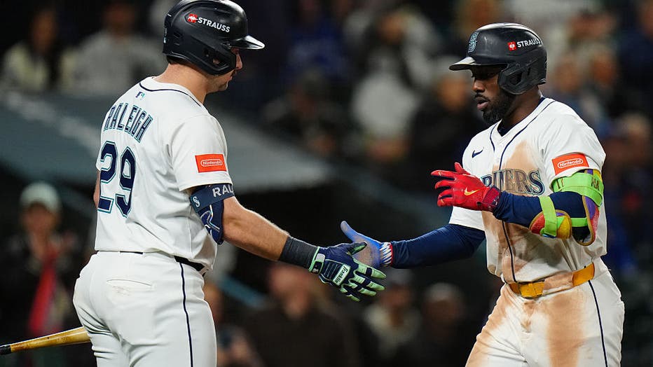 SEATTLE, WA - OCTOBER 15: Randy Arozarena #56 of the Seattle Mariners celebrates with Cal Raleigh #29 after hitting a solo home run in the eighth inning during Game Three of the American League Championship Series presented by loanDepot between the Toronto Blue Jays and the Seattle Mariners at T-Mobile Park on Wednesday, October 15, 2025 in Seattle, Washington.