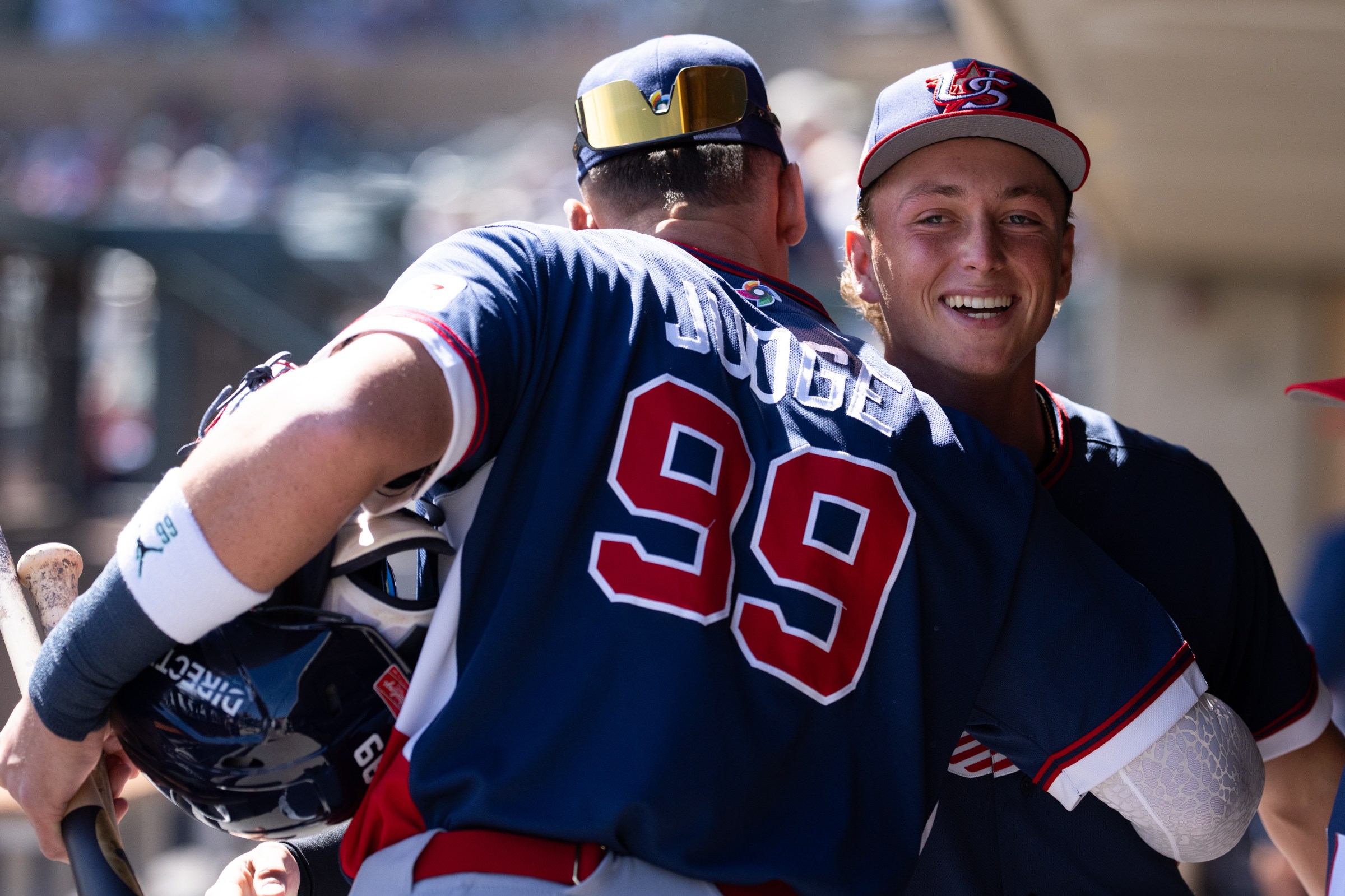 SCOTTSDALE, ARIZONA - MARCH 04: Ethan Holliday of the Colorado Rockies is greeted in the dugout by teammate Aaron Judge #99 of Team United States during an exhibition game at at Salt River Fields at Talking Stick on March 04, 2026 in Scottsdale, Arizona. (Photo by Kyle Cooper/Colorado Rockies/Getty Images)