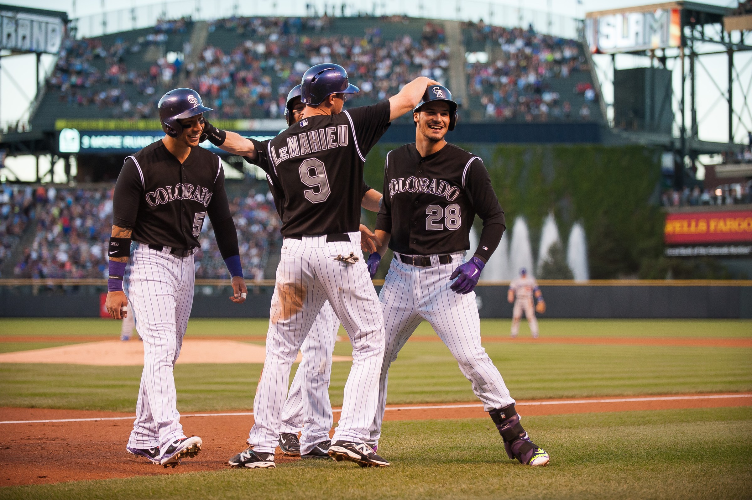 DENVER, CO - SEPTEMBER 26: Nolan Arenado #28 of the Colorado Rockies celebrates with Carlos Gonzalez #5, DJ LeMahieu #9, and Charlie Blackmon #19 after hitting a first inning grand slam home run off of Brett Anderson #35 of the Los Angeles Dodgers during a game at Coors Field on September 26, 2015 in Denver, Colorado. (Photo by Dustin Bradford/Getty Images)