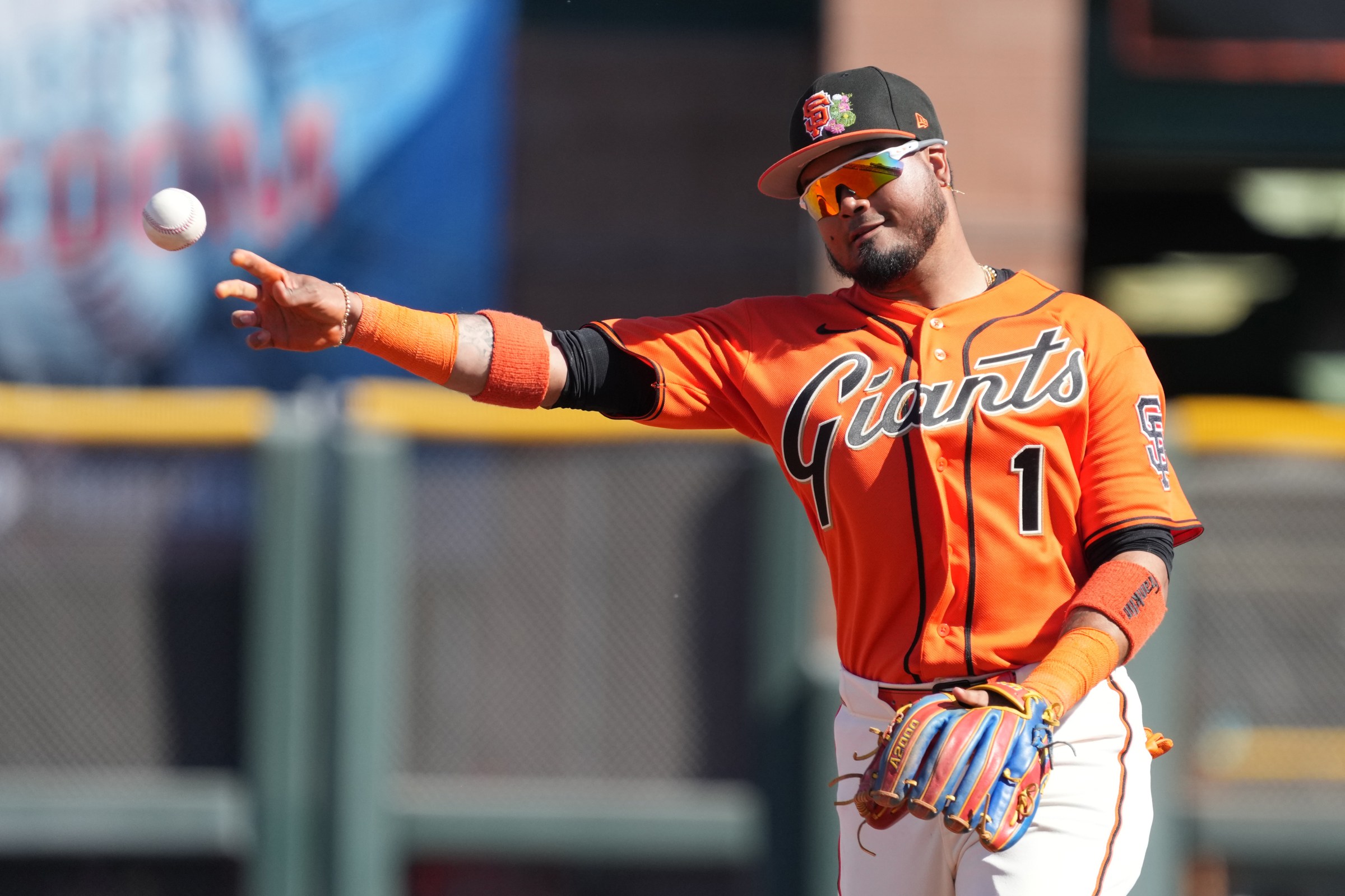 Feb 22, 2026; Scottsdale, Arizona, USA; San Francisco Giants infielder Luis Arraez (1) flips the ball aginst the Chicago Cubs in the third inning at Scottsdale Stadium. Mandatory Credit: Rick Scuteri-Imagn Images