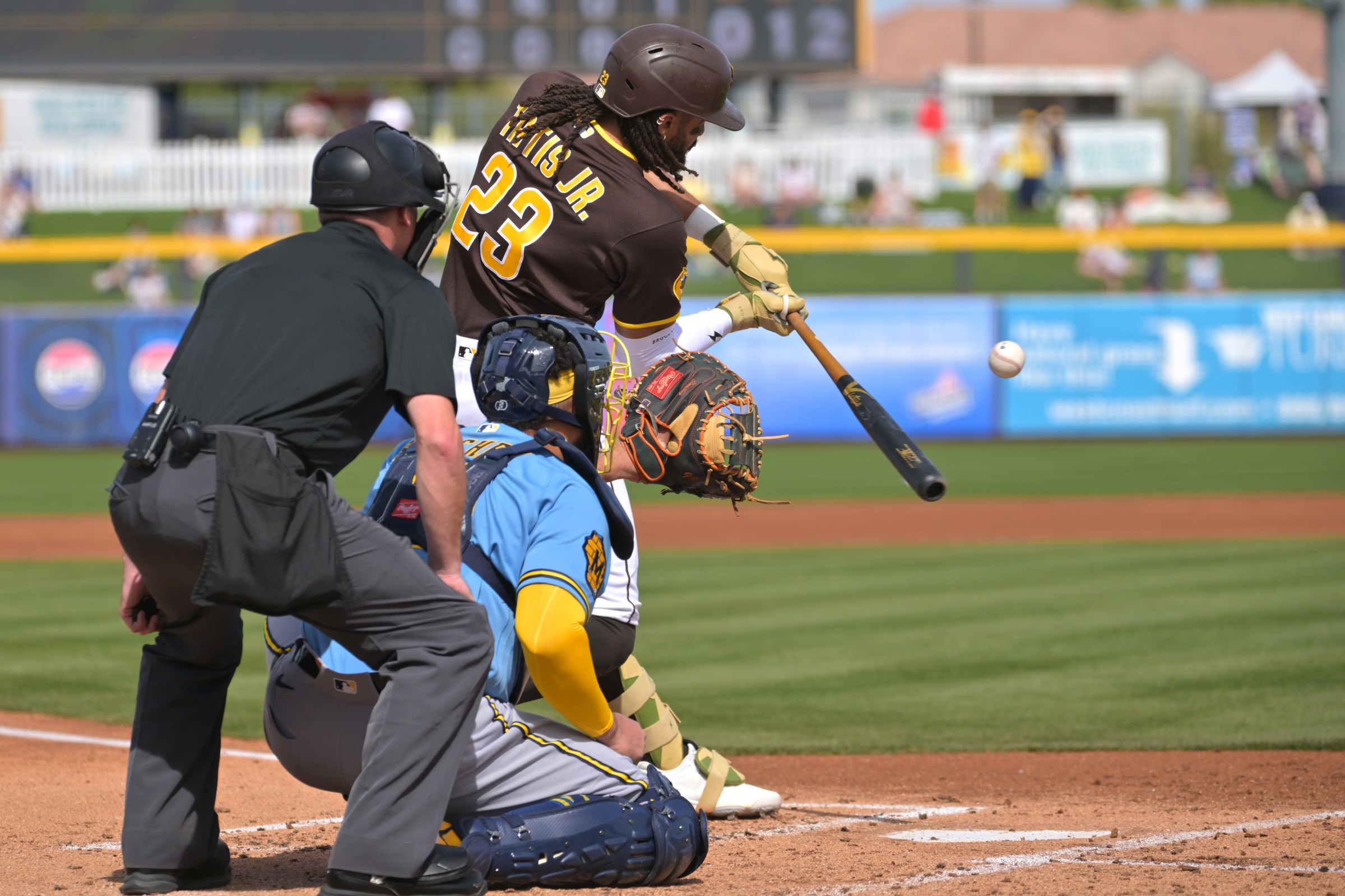 Feb 23, 2026; Peoria, Arizona, USA; San Diego Padres designated hitter Fernando Tatis Jr. (23) on deck in the first inning against the Milwaukee Brewers at Peoria Sports Complex. Mandatory Credit: Jayne Kamin-Oncea-Imagn Images