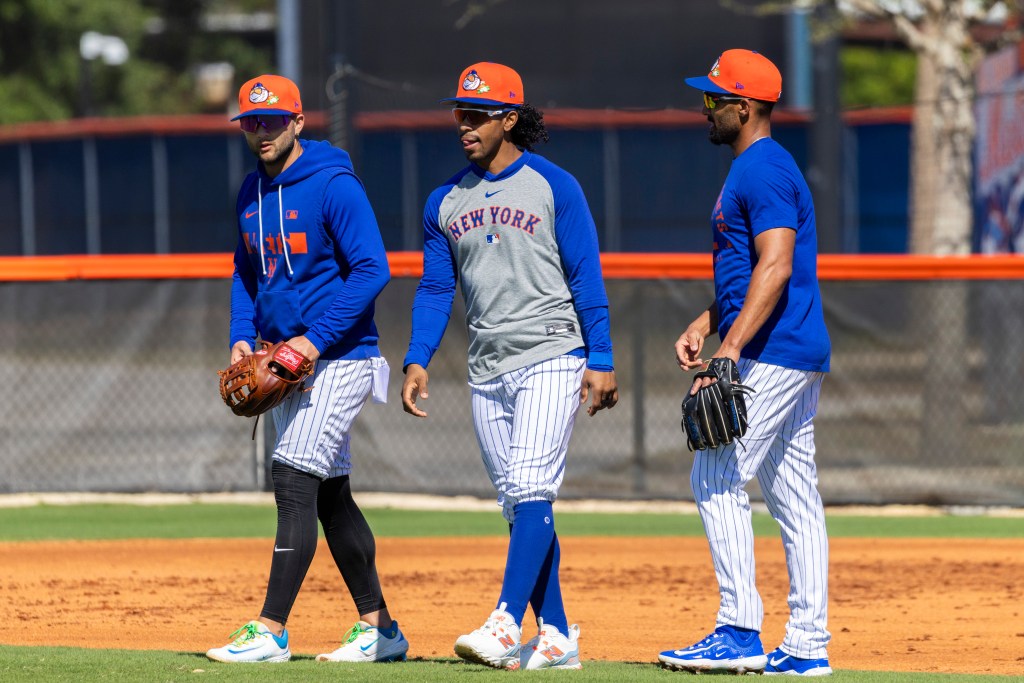 Bo Bichette (left), Francisco Lindor (center), and Marcus Semien (right) walk together during Spring Training.