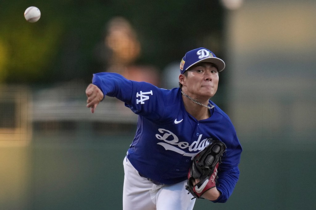 Dodgers pitcher Yoshinobu Yamamoto throws a pitch during a spring training game.
