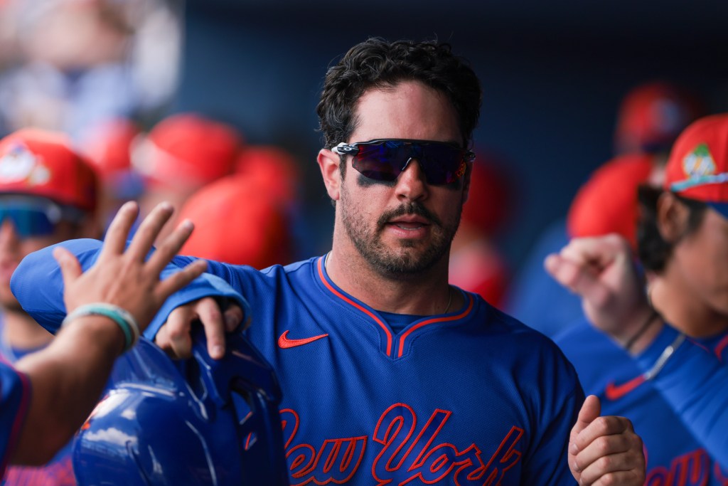 New York Mets left fielder Mike Tauchman (50) celebrates after scoring during a spring training game.