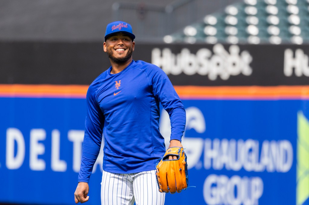 New York Mets Pitcher Freddy Peralta smiles during a workout.