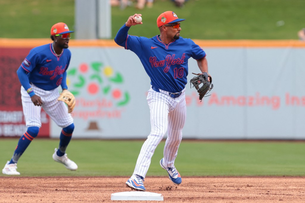 New York Mets second baseman Marcus Semien (10) throwing to first.