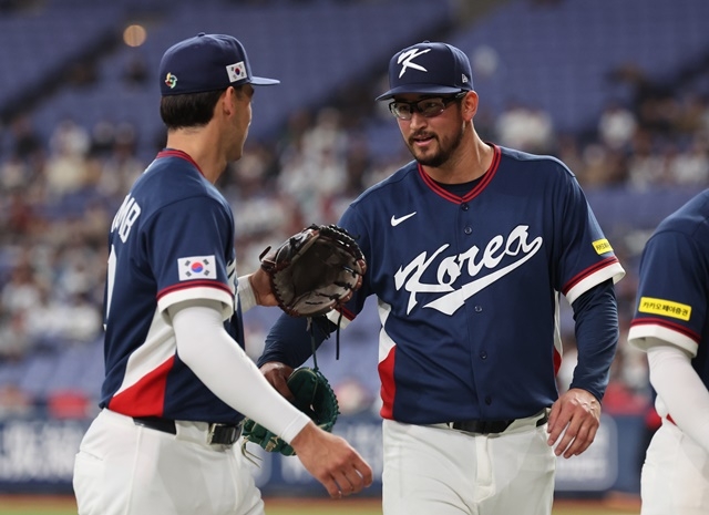At the World Baseball Classic warm-up match between the Korean national team and the Orix Buffaloes in Japanese pro baseball at Kyocera Dome in Osaka, Japan on Sunday. Korean pitcher Dane Dunning (right) enters the dugout to cheer up Shay Wittcomb and each other after finishing the third inning without allowing a run. Photo = Yonhap News