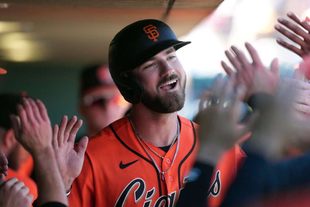Bryce Eldridge of the San Francisco Giants smiles and celebrates with teammates.