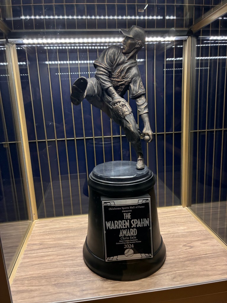 Warren Spahn Award trophy presented by the Oklahoma Sports Hall of Fame, featuring a bronze pitcher statue on a black pedestal.