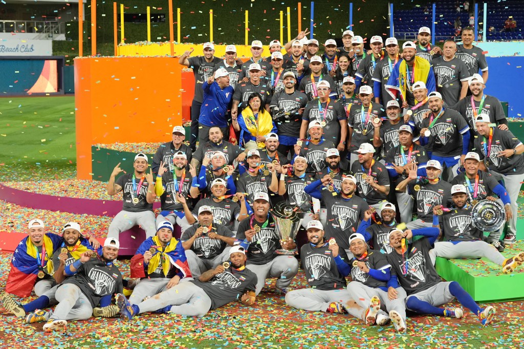 The Venezuela team celebrates with their gold medals and trophy after winning the World Baseball Classic.