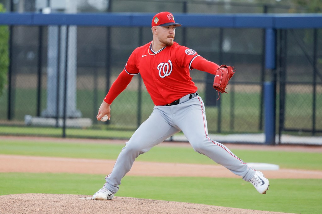 Washington Nationals pitcher Cade Cavalli throws a pitch during spring training workouts.