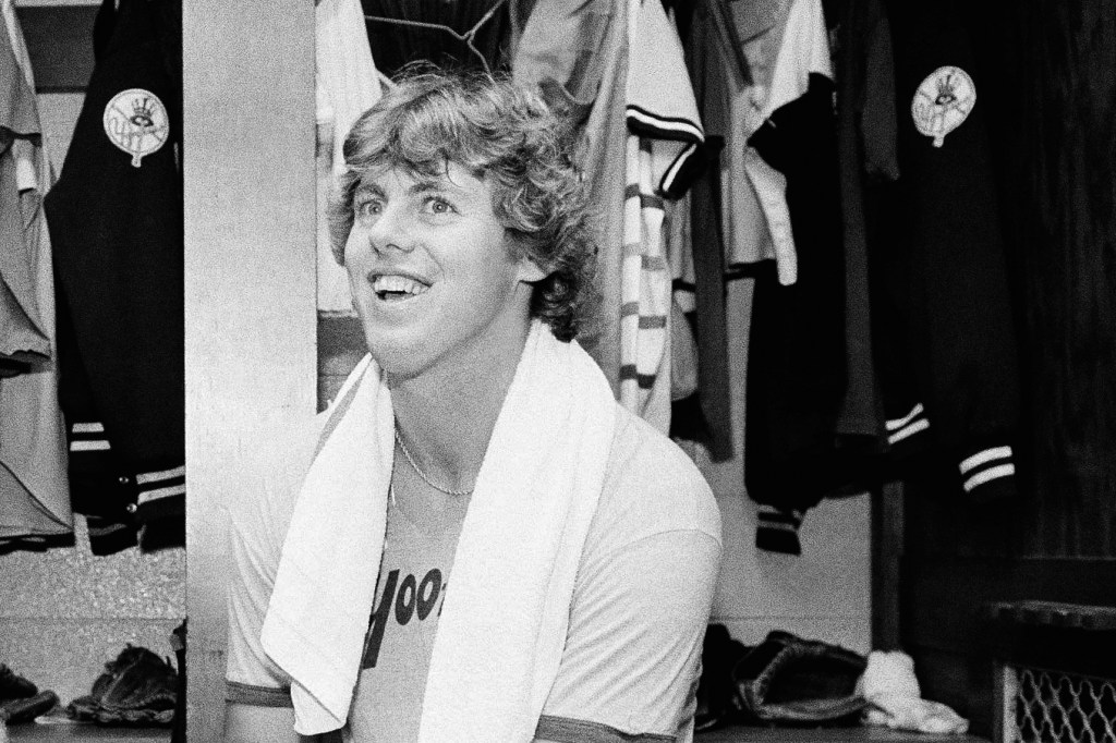 Ken Clay smiling in the dressing room after a Yankees victory.