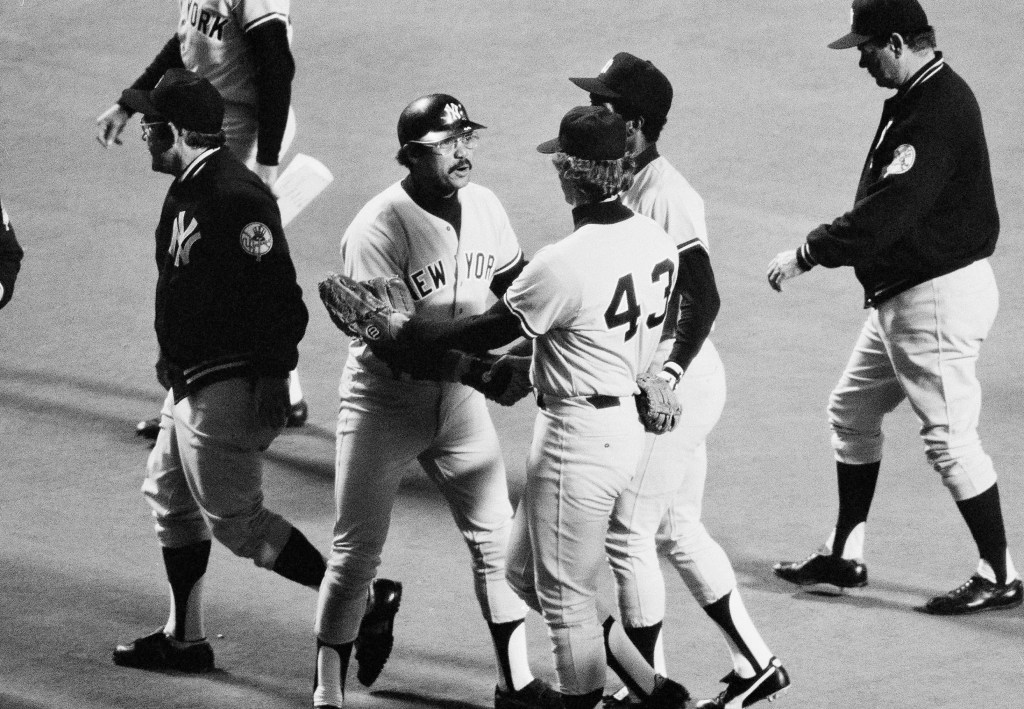 Baseball players Reggie Jackson and Ken Clay congratulate each other on the field.
