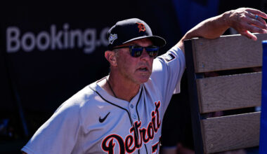 Detroit Tigers first base coach Anthony Iapoce (76) watches warm up from the dugout before Game 2 of AL wild-card series against Cleveland Guardians at Progressive Field in Cleveland, Ohio on Wednesday, Oct. 1, 2025.