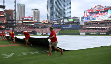 Jul 13, 2025; St. Louis, Missouri, USA;  St. Louis Cardinals grounds crew pulls the tarp on the field during a rain delay in the third inning of a game between the St. Louis Cardinals and the Atlanta Braves at Busch Stadium. Mandatory Credit: Jeff Curry-Imagn Images