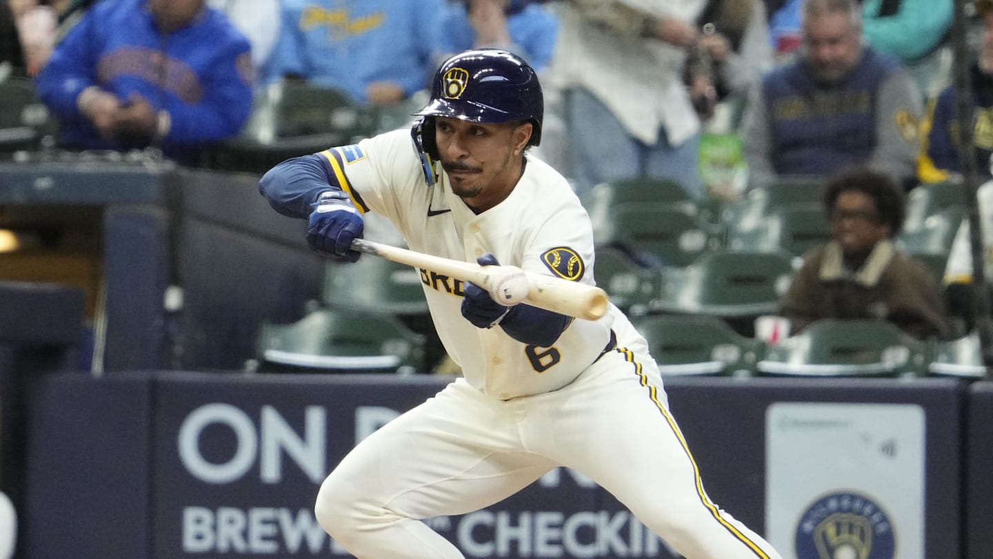 Apr 1, 2026; Milwaukee, Wisconsin, USA;  Milwaukee Brewers second baseman David Hamilton (6) bunts the ball against the Tampa Bay Rays for hit on an errand throw in the third inning at American Family Field. Mandatory Credit: Michael McLoone-Imagn Images