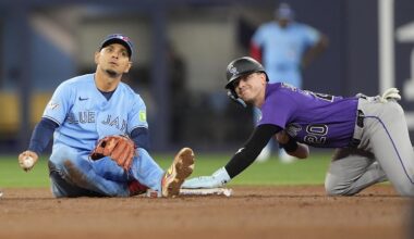 Apr 1, 2026; Toronto, Ontario, CAN; Colorado Rockies right fielder Troy Johnston (20) reacts after stealing second base against Toronto Blue Jays shortstop Andres Gimenez (0) during the eighth inning at Rogers Centre. Mandatory Credit: John E. Sokolowski-Imagn Images