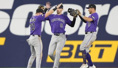 Apr 1, 2026; Toronto, Ontario, CAN; Colorado Rockies left fielder Troy Johnston (20) and center fielder Brenton Doyle (9)  and right fielder Tyler Freeman (2) celebrate a win over the Toronto Blue Jays after the tenth inning at Rogers Centre. Mandatory Credit: John E. Sokolowski-Imagn Images