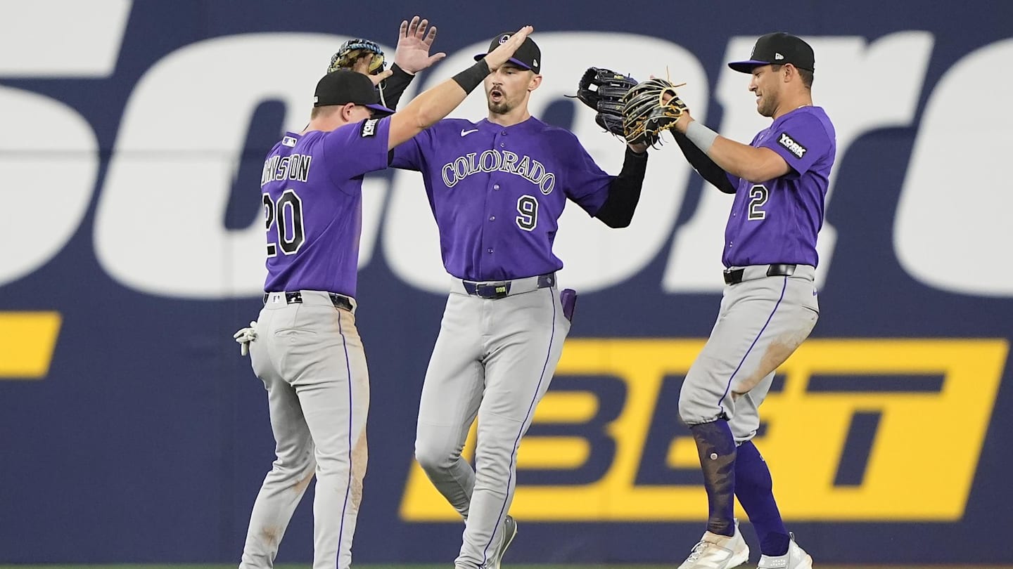 Apr 1, 2026; Toronto, Ontario, CAN; Colorado Rockies left fielder Troy Johnston (20) and center fielder Brenton Doyle (9)  and right fielder Tyler Freeman (2) celebrate a win over the Toronto Blue Jays after the tenth inning at Rogers Centre. Mandatory Credit: John E. Sokolowski-Imagn Images