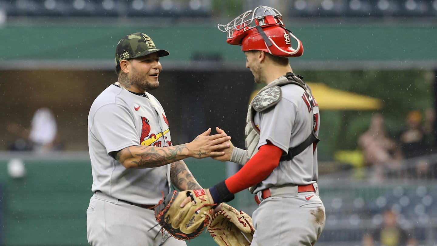 May 22, 2022; Pittsburgh, Pennsylvania, USA;  St. Louis Cardinals catchers Yadier Molina (left) and Andrew Knizner (right) celebrate after defeating the Pittsburgh Pirates at PNC Park. The Cardinals won 18-4. Mandatory Credit: Charles LeClaire-Imagn Images