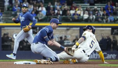 Apr 1, 2026; Milwaukee, Wisconsin, USA; Milwaukee Brewers center fielder Garrett Mitchell (5) slides in safely ahead of the tag by Tampa Bay Rays third baseman Ben Williamson (15) in the third inning at American Family Field. Mandatory Credit: Michael McLoone-Imagn Images