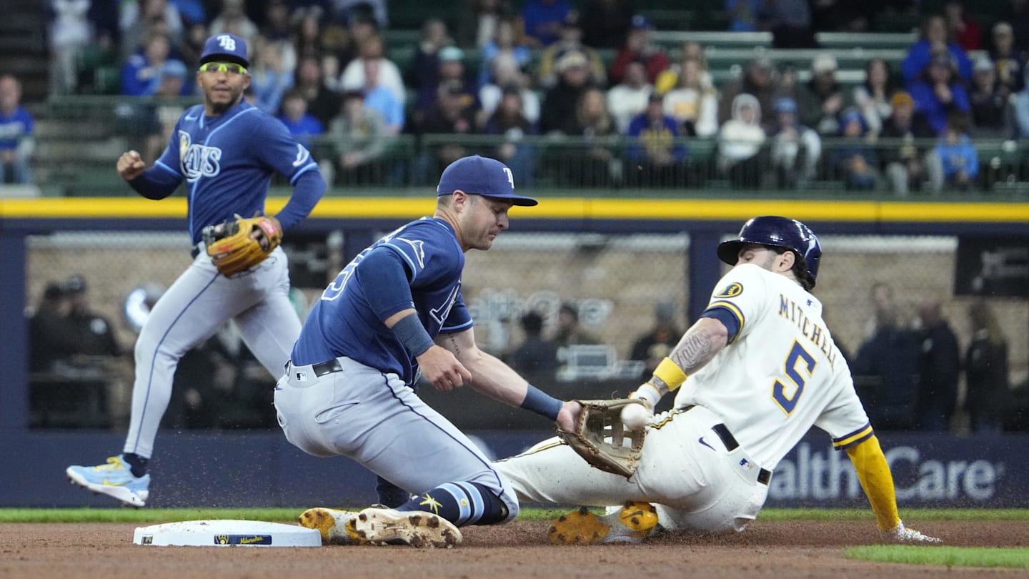 Apr 1, 2026; Milwaukee, Wisconsin, USA; Milwaukee Brewers center fielder Garrett Mitchell (5) slides in safely ahead of the tag by Tampa Bay Rays third baseman Ben Williamson (15) in the third inning at American Family Field. Mandatory Credit: Michael McLoone-Imagn Images