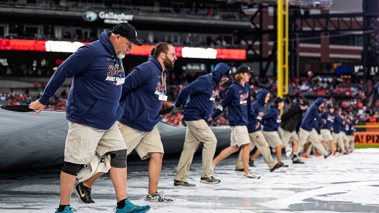 Detroit Tigers grounds crew remove the tarp from the field after the rain delay during ALDS Game 3 between Detroit Tigers and Seattle Mariners at Comerica Park in Detroit on Tuesday, Oct. 7, 2025.