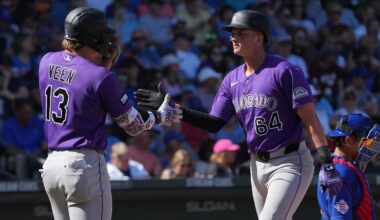 Feb 25, 2026; Mesa, Arizona, USA; Colorado Rockies first baseman T.J. Rumfield (64) celebrates with left fielder Zac Veen after hitting a solo home run against the Chicago Cubs in the second inning at Sloan Park. Mandatory Credit: Rick Scuteri-Imagn Images