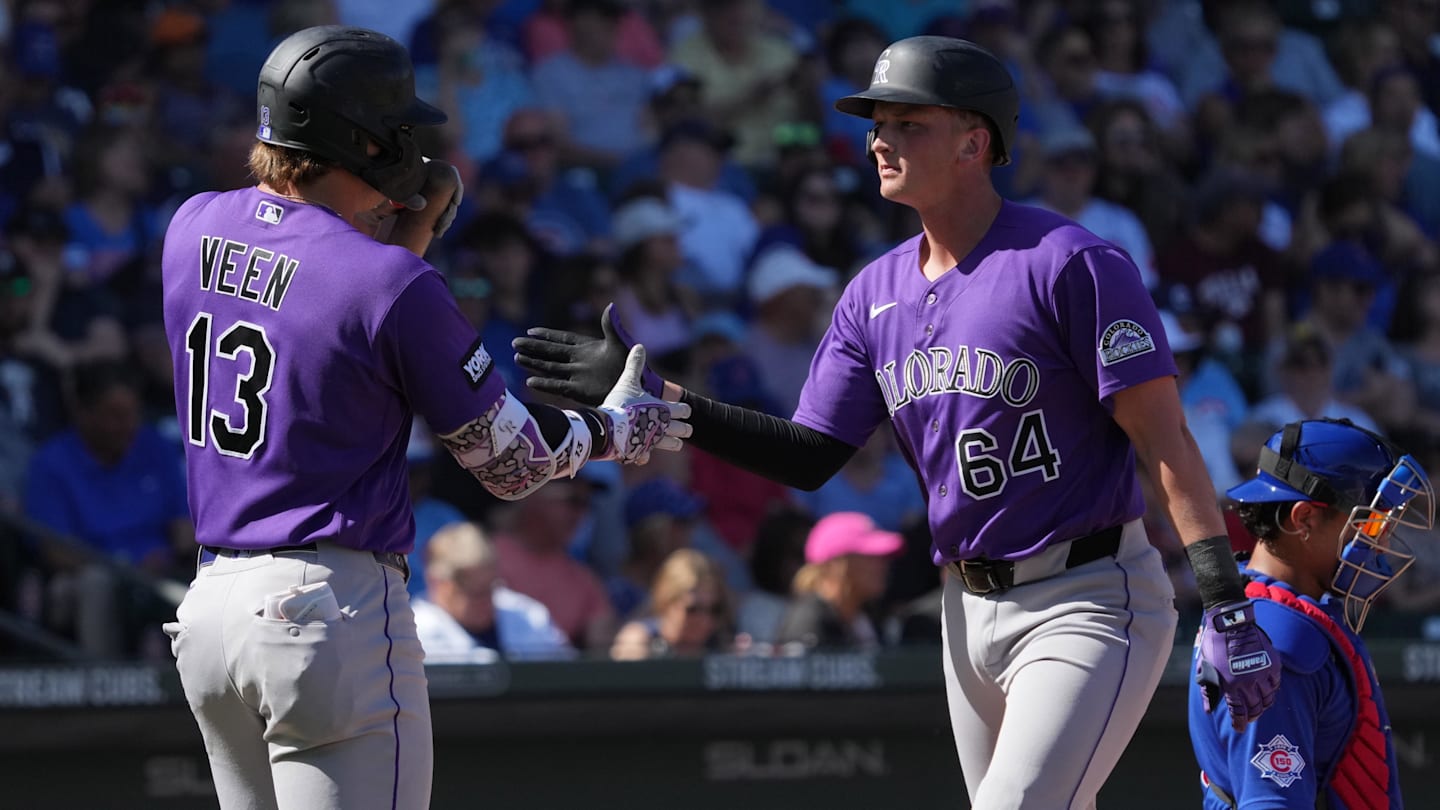 Feb 25, 2026; Mesa, Arizona, USA; Colorado Rockies first baseman T.J. Rumfield (64) celebrates with left fielder Zac Veen after hitting a solo home run against the Chicago Cubs in the second inning at Sloan Park. Mandatory Credit: Rick Scuteri-Imagn Images